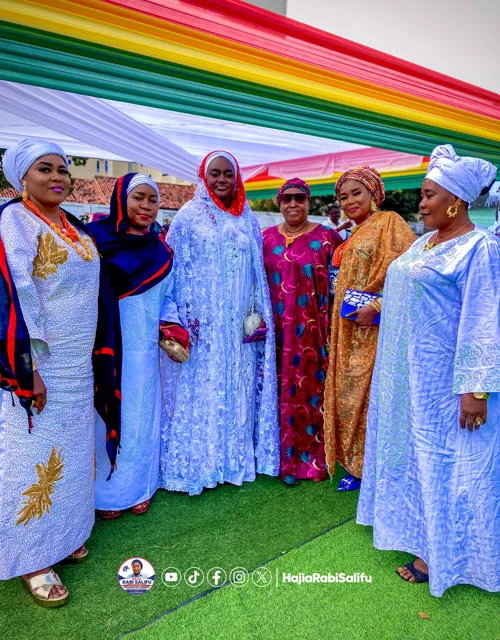 A group portrait beneath a colourful canopy